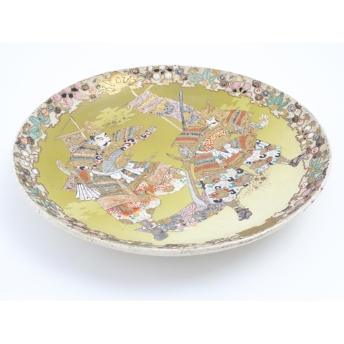 204 - A Japanese Satsuma charger decorated with two Samurai warriors. Character marks under. Approx. 12 1/... 