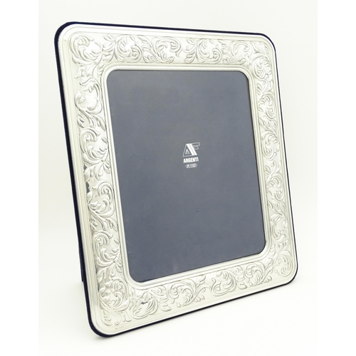 500 - An easel back photograph frame with .925 silver surround with acanthus scroll detail. Approx. 14