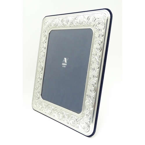 500 - An easel back photograph frame with .925 silver surround with acanthus scroll detail. Approx. 14