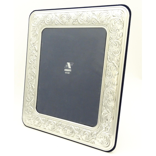 500 - An easel back photograph frame with .925 silver surround with acanthus scroll detail. Approx. 14