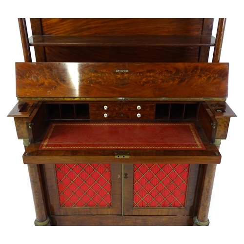 1455 - A 19thC mahogany secretaire desk in the French Empire style, the super structure formed as a bookcas... 