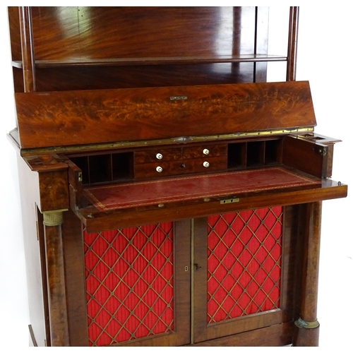 1455 - A 19thC mahogany secretaire desk in the French Empire style, the super structure formed as a bookcas... 