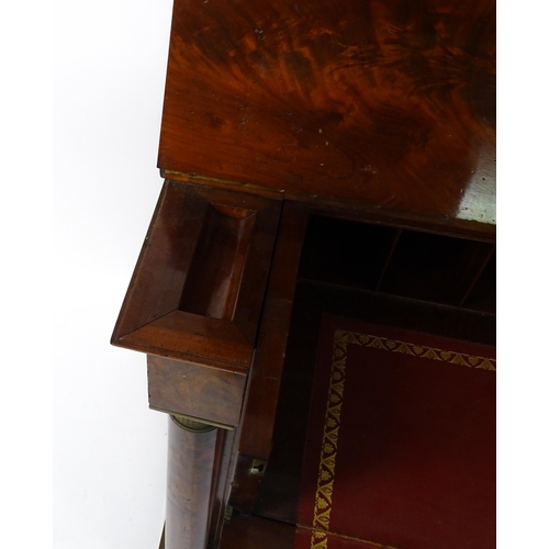 1455 - A 19thC mahogany secretaire desk in the French Empire style, the super structure formed as a bookcas... 