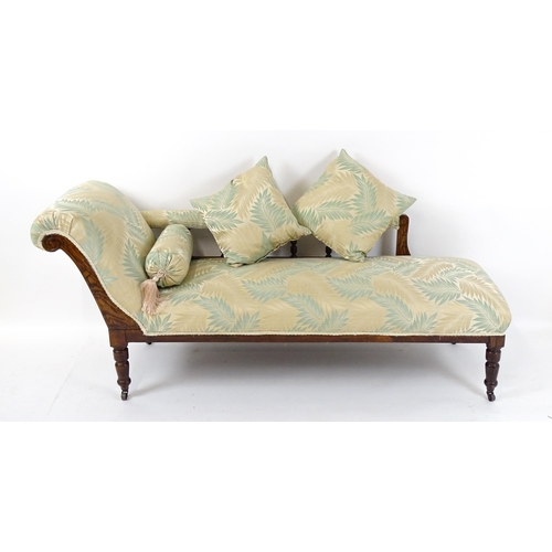 1458 - An early / mid 20thC chaise longue with a scrolled end and upholstered backrest with turned supports... 