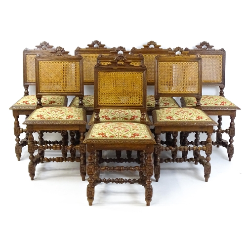 1489 - A set of eight early 20thC oak dining chairs with pierced cresting rails above caned backrests and u... 