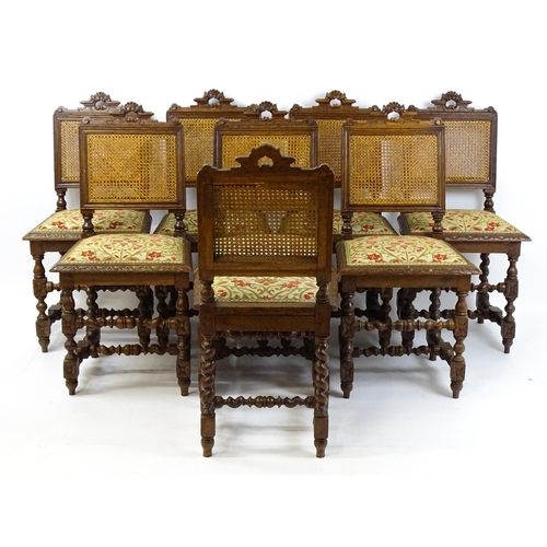 1489 - A set of eight early 20thC oak dining chairs with pierced cresting rails above caned backrests and u... 