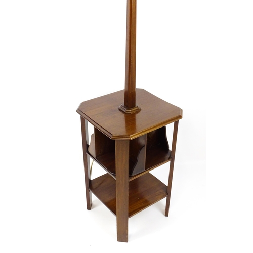 1514 - An Art Deco mahogany lamp stand with a canted stem above a three tier table base with a revolving bo... 