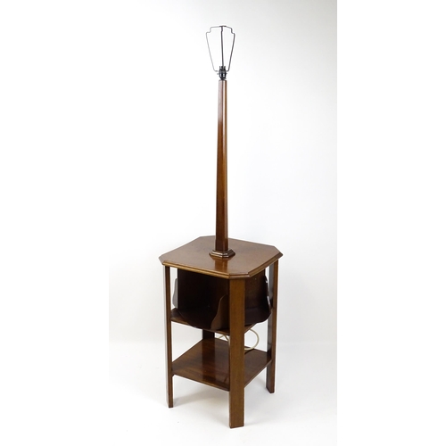 1514 - An Art Deco mahogany lamp stand with a canted stem above a three tier table base with a revolving bo... 