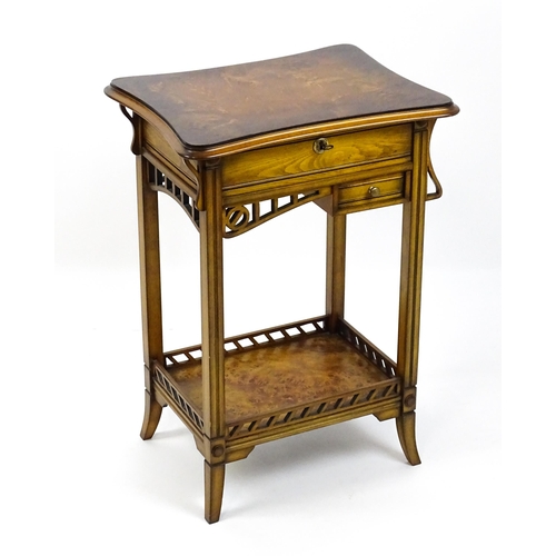 1515 - A late 20thC sewing table with a hinged top opening to show fitted compartments, a mirror, and an ad... 