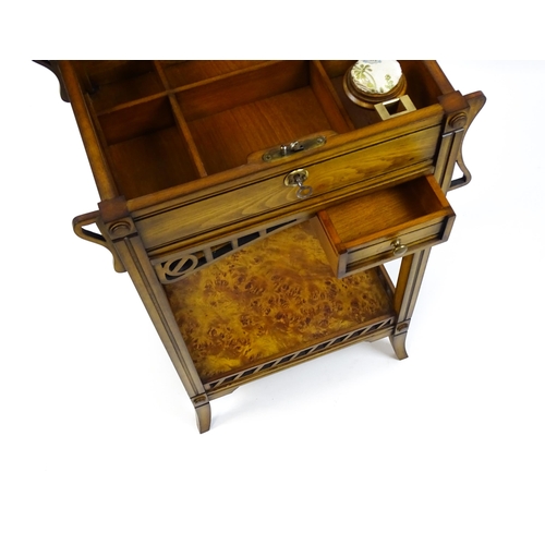 1515 - A late 20thC sewing table with a hinged top opening to show fitted compartments, a mirror, and an ad... 