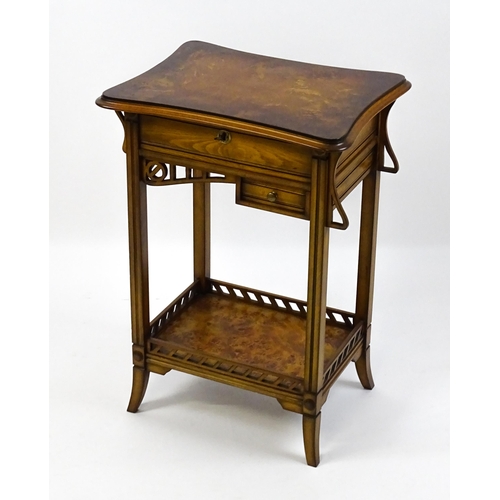 1515 - A late 20thC sewing table with a hinged top opening to show fitted compartments, a mirror, and an ad... 