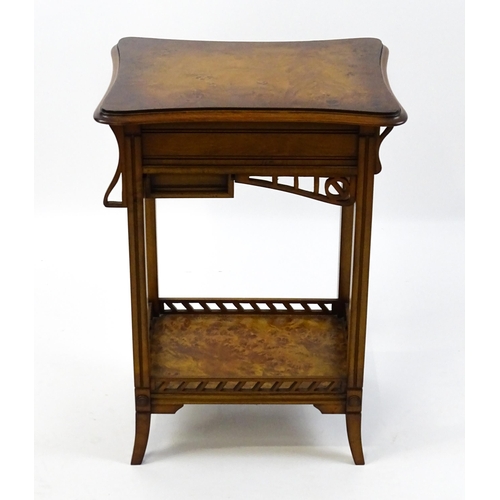 1515 - A late 20thC sewing table with a hinged top opening to show fitted compartments, a mirror, and an ad... 