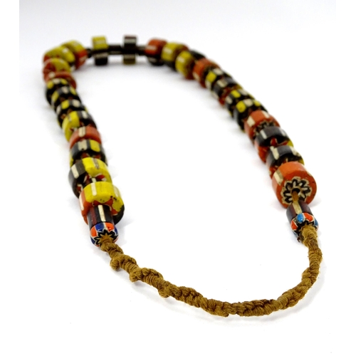 780A - A quantity of assorted ethnic jewellery to include various beads, necklace, pendants, etc.