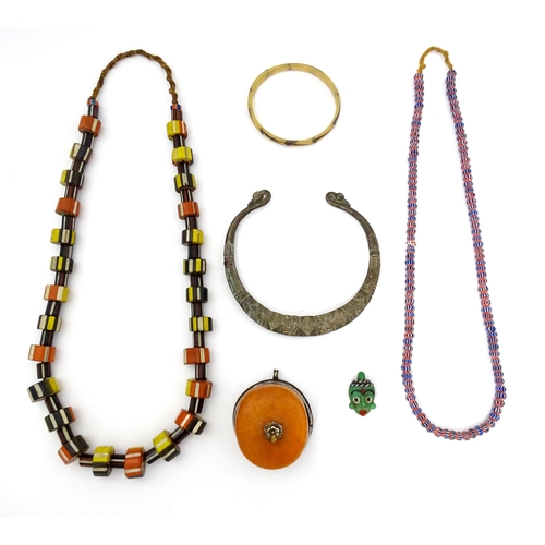 780A - A quantity of assorted ethnic jewellery to include various beads, necklace, pendants, etc.