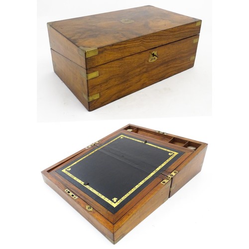 1256 - A Victorian walnut writing slope with brass mounts, the escutcheon dated 1898, opening to reveal a f... 