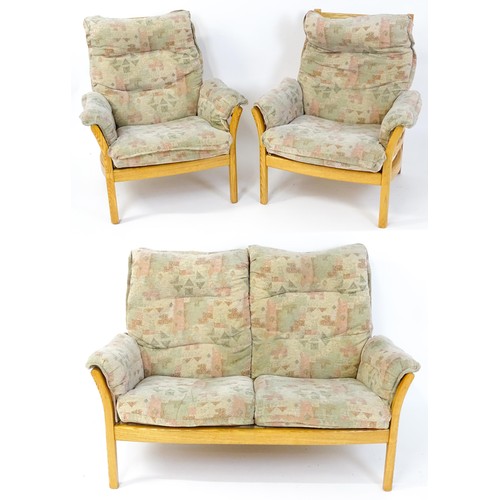 1637 - A modern Ercol three-piece suite, model 930LT, comprising two-seater sofa and two armchairs with gre... 