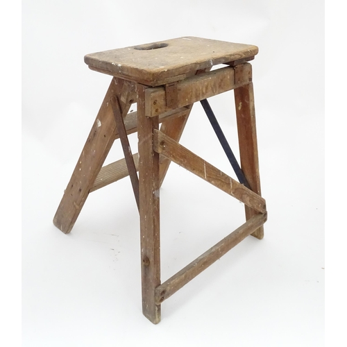 28 - A mid 20thC folding wooden step, constructed from pine with steel braces, approx 23