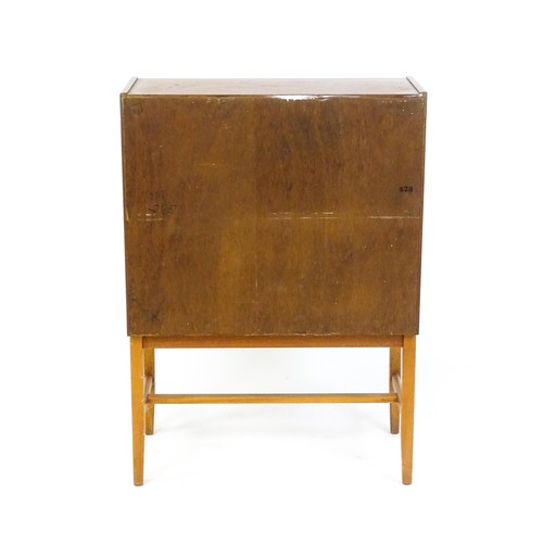 70 - Vintage / Retro: A teak desk, bureau with a fall front above two short drawers raised on four taperi... 