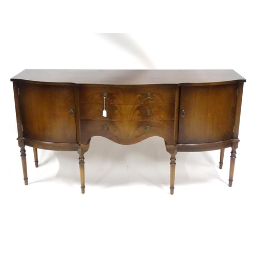 75 - A 20thC mahogany sideboard with shaped front,  comprising two cupboards with shelves and opposing do... 