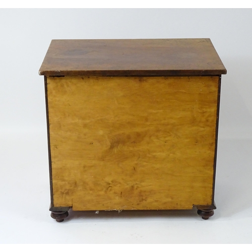 81 - A 19thC mahogany commode with a hinged top, four turned knob handles and raised on four turned feet.... 