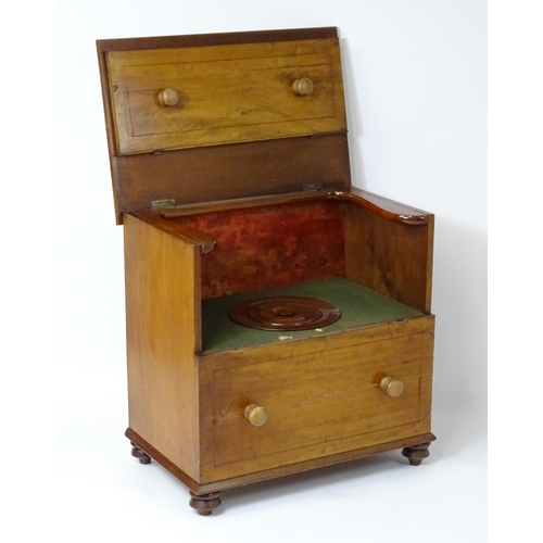 81 - A 19thC mahogany commode with a hinged top, four turned knob handles and raised on four turned feet.... 