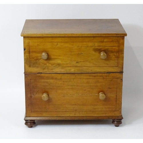 81 - A 19thC mahogany commode with a hinged top, four turned knob handles and raised on four turned feet.... 