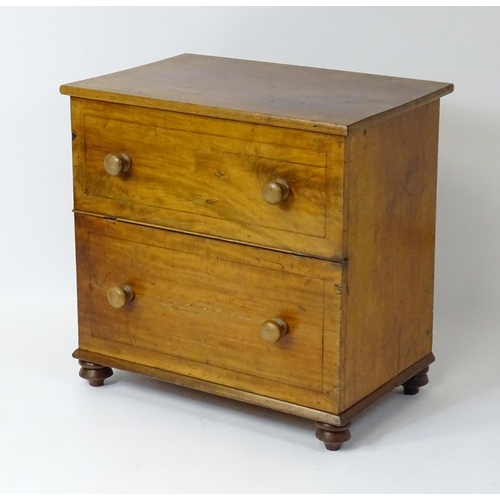 81 - A 19thC mahogany commode with a hinged top, four turned knob handles and raised on four turned feet.... 