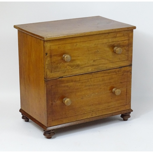 81 - A 19thC mahogany commode with a hinged top, four turned knob handles and raised on four turned feet.... 