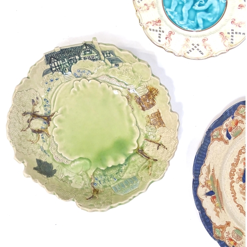 204 - A quantity of assorted ceramics to include two large faience chargers with banded detail, a studio p... 