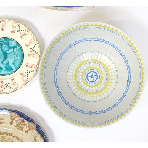 204 - A quantity of assorted ceramics to include two large faience chargers with banded detail, a studio p... 