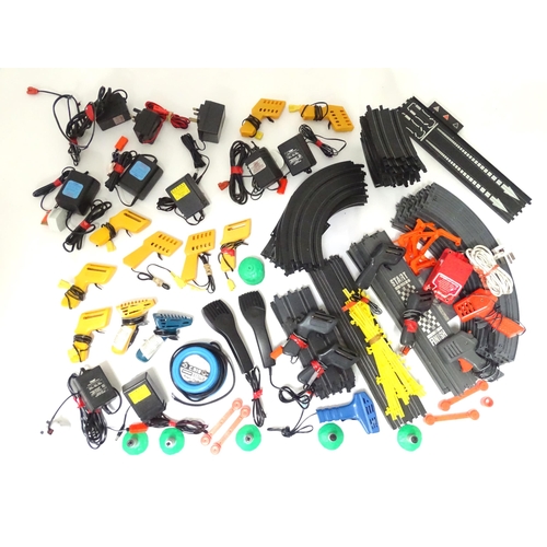 214 - Toys : a large quantity of track sections, controllers and power adapters for mid 20thC toy car raci... 