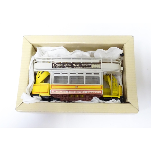 308 - Toys: A Corgi die cast scale model Double Deck Tram Plymouth no. 97269. Together with a Burago Porsc... 