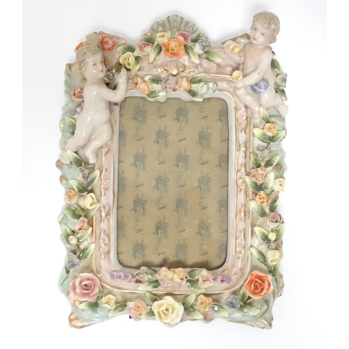 315 - A quantity of assorted ceramics to include a German photograph frame with ceramic surround decorated... 