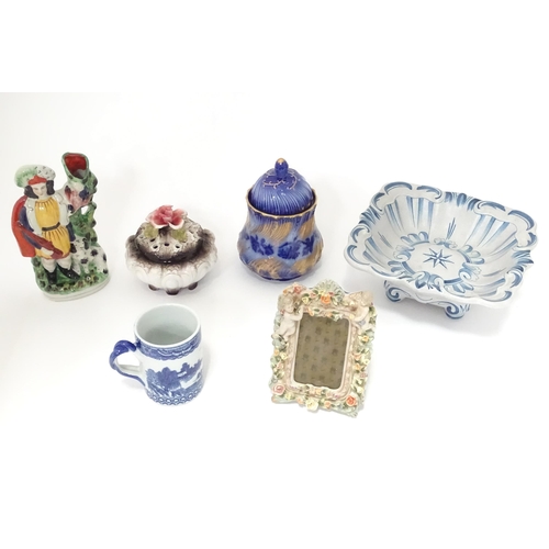 315 - A quantity of assorted ceramics to include a German photograph frame with ceramic surround decorated... 