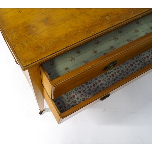 566 - An early 20thC dressing table with an oval mirror above two long drawers and raised on four tapering... 