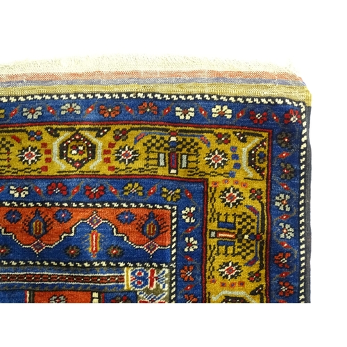 626 - Carpet / Rug :  A blue and red ground rug the central motif with floral and geometric detail and ban... 