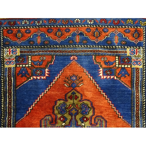 626 - Carpet / Rug :  A blue and red ground rug the central motif with floral and geometric detail and ban... 