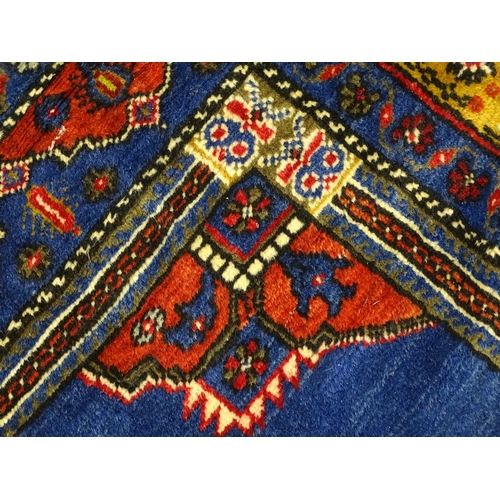 626 - Carpet / Rug :  A blue and red ground rug the central motif with floral and geometric detail and ban... 