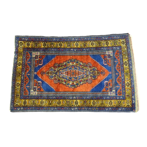 626 - Carpet / Rug :  A blue and red ground rug the central motif with floral and geometric detail and ban... 