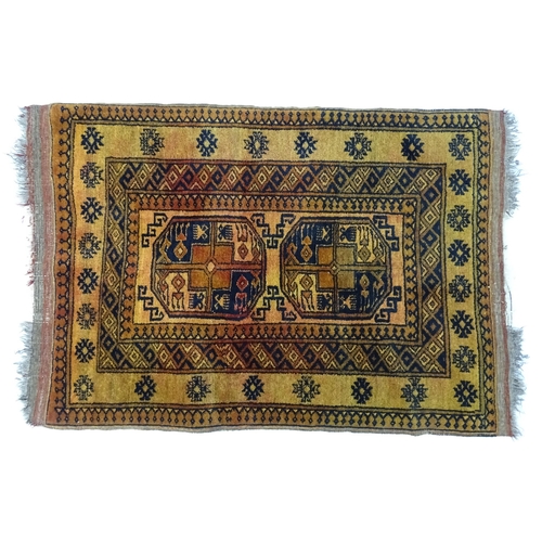 628 - Carpet / Rug: An ochre ground rug decorated with centre vignettes with geometric motifs, further rep... 