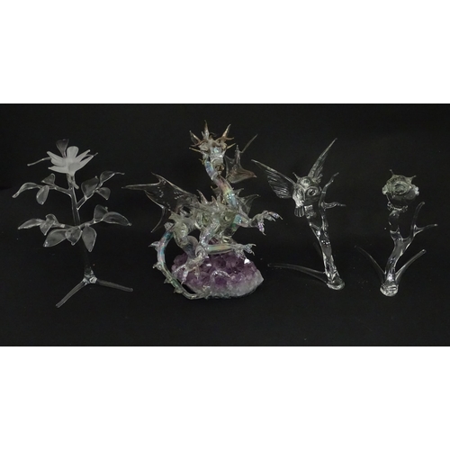 632 - A quantity of assorted glass ornaments to include a model of a dragon mounted on an amethyst specime... 