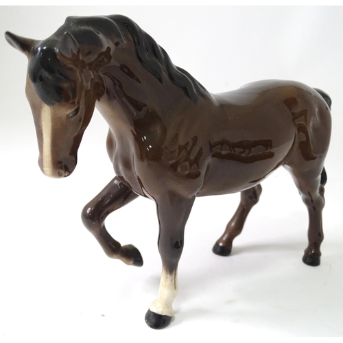 692 - Three models of horses comprising a Beswick pony, a small white horse, and a resin example with a pl... 