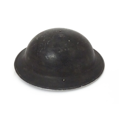 12 - Militaria , WWII / World War 2 / WW2 / Second World War : a steel brodie helmet, with black painted ... 