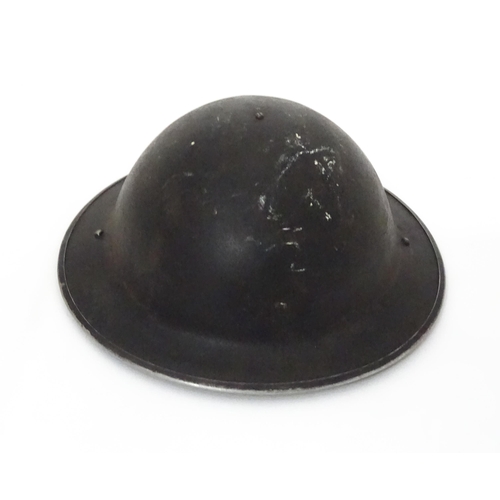 12 - Militaria , WWII / World War 2 / WW2 / Second World War : a steel brodie helmet, with black painted ... 