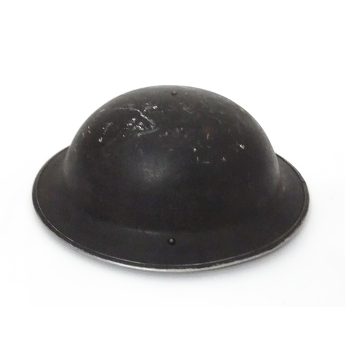 12 - Militaria , WWII / World War 2 / WW2 / Second World War : a steel brodie helmet, with black painted ... 