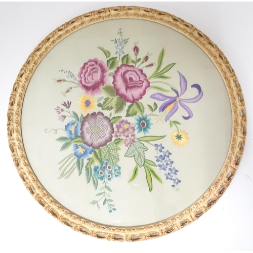 639 - A 20thC needlework embroidery depicting flowers and foliage. Approx. 18 1/2