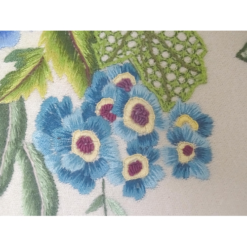 639 - A 20thC needlework embroidery depicting flowers and foliage. Approx. 18 1/2