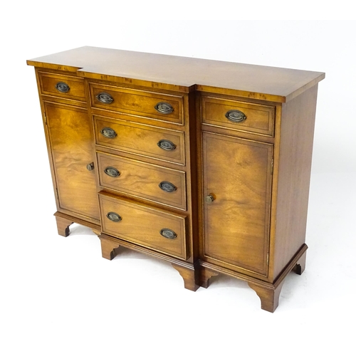 235 - A late 20thC walnut break-front sideboard of small proportions, comprising a flight of four graduate... 