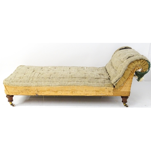 261 - A Victorian chaise longue / day bed, the mahogany frame with scrolling end and raised on four turned... 