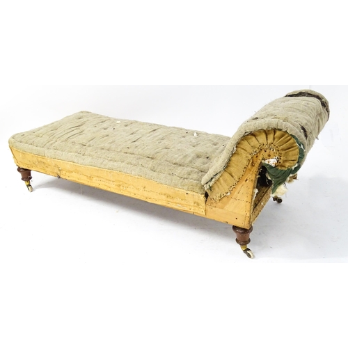 261 - A Victorian chaise longue / day bed, the mahogany frame with scrolling end and raised on four turned... 